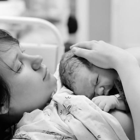 Woman with newborn baby right after delivery