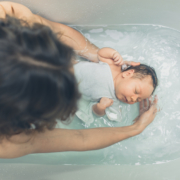 Baby in the bathtub with mother
